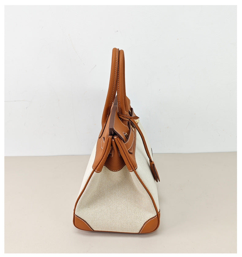 Top Handle Bag in Pebbled Grain Leather & Canvas with Gold-Tone Twist Lock detail image 2