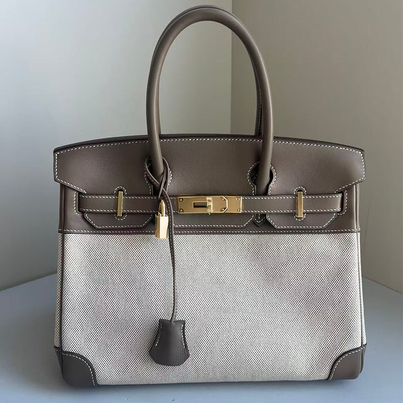 Top Handle Bag in Pebbled Grain Leather & Canvas with Gold-Tone Twist Lock detail image 10